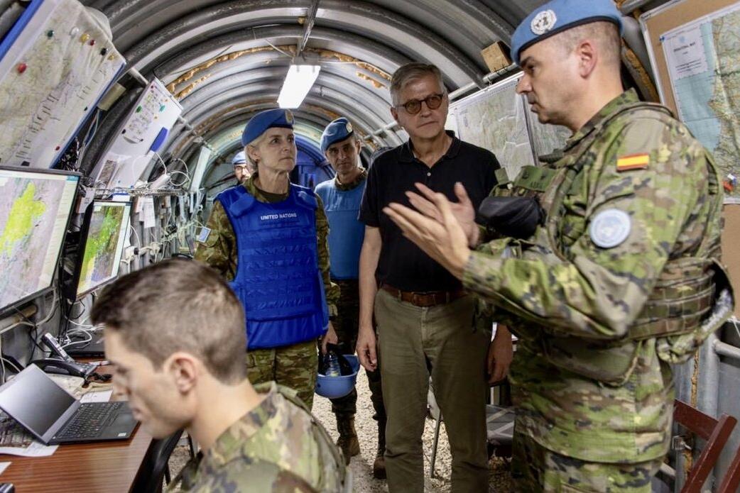 Jean-Pierre Lacroix converses with peacekeepers in a technical environment.